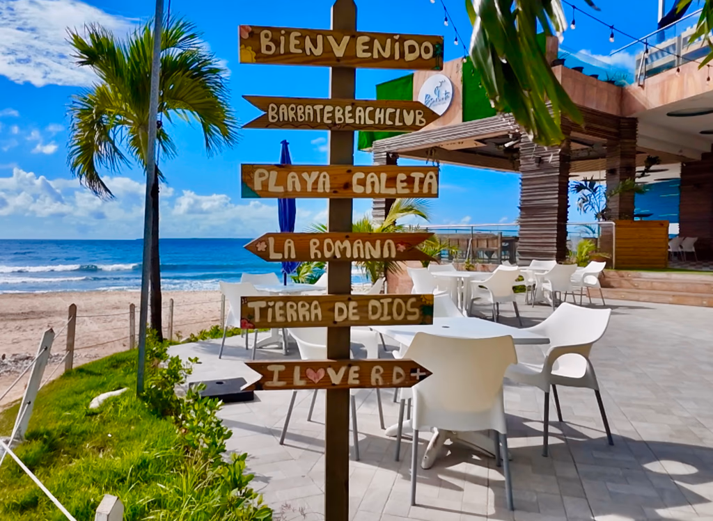 Tropical resort with directional signs showing various destinations in La Romana